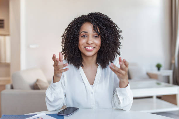 istock African-american elegant female entrepreneur discussing while having a conference call Portrait of confident ethnicity female employee looking at camera talking on video call in the home office. 1367626159