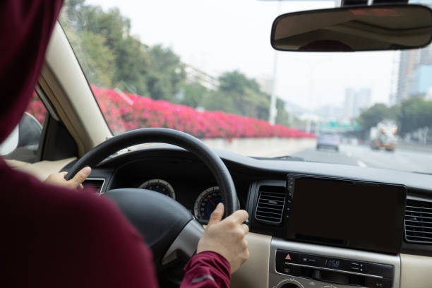 istock People driving car on city road 1367629315