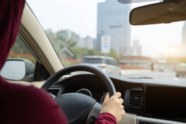 istock People driving car on city road 1367629323