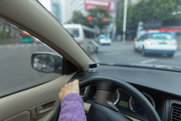 istock People driving car on city road 1367629351