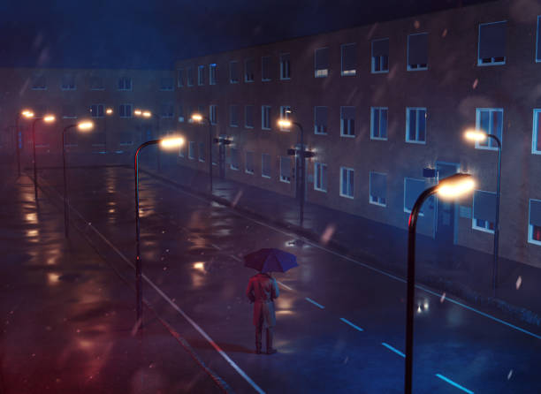 istock One man stands in an empty street at night while it rains 1367630515