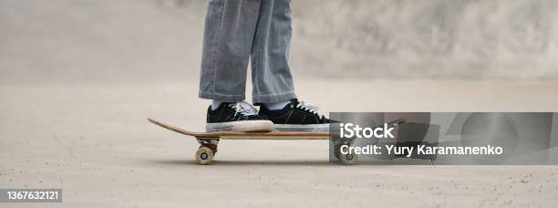 Foot Of Skateboarder Standing On The Skateboard On The City Street Stock Photo - Download Image Now