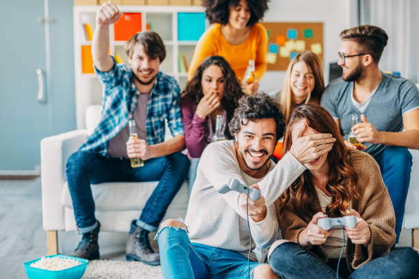 istock Colleagues playing video games in the office relax room 1367633241