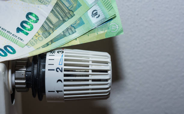 istock Energy prices increase and energy consumption thermostatic regulator from heating with 100 euro bills 1367634698
