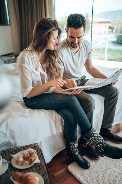 istock couple reading the newspaper on the hotel 1367634807