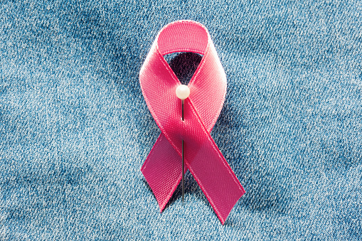 Pink ribbon on jeans. Idea for world breast cancer day