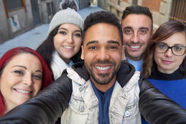 istock Smiling diverse friends taking selfie in alley 1367637040