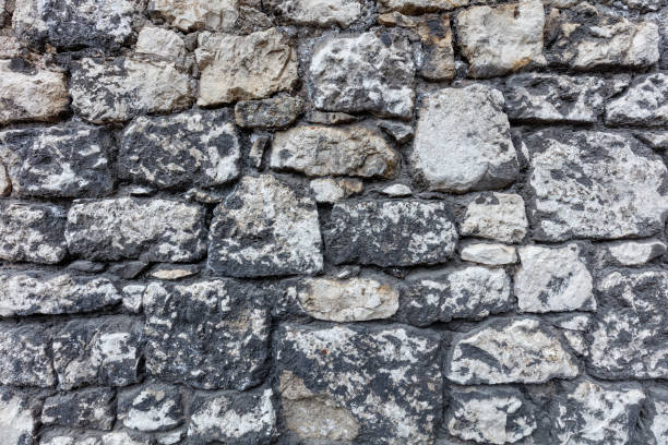 istock Fragment of an old gray stone wall old gray masonry 1367638270