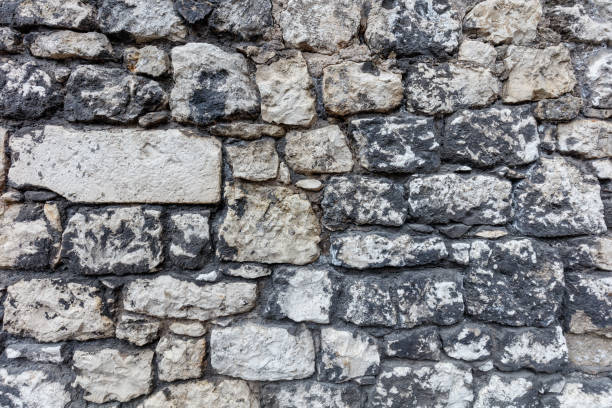 istock Fragment of an old gray stone wall old gray masonry 1367638272