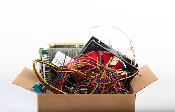 istock Computer parts and colored cable waste in cardboard box. 1367642300