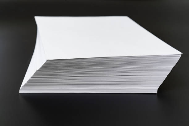 istock a stack of sheets of white paper on a black background. 1367645211