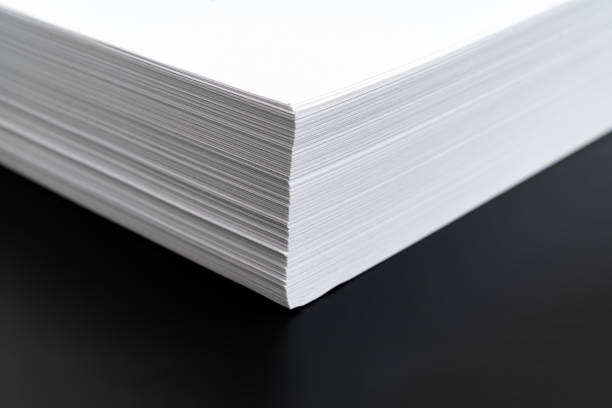 istock close-up a stack angle of sheets of white paper on a black background. 1367645291
