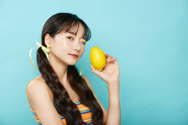 Fresh portrait of young Asian woman on blue background Background Pigtails stock pictures, royalty-free photos & images