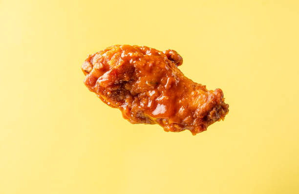 istock A piece of fried buffalo chicken wing on a bright background. 1367647797
