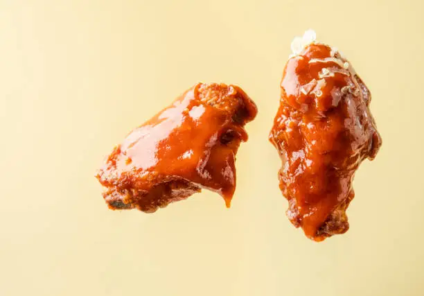 Pieces of fried chicken on a bright background. Buffalo chicken wings.