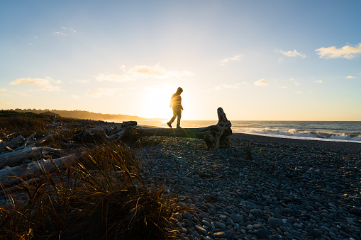 Enjoying outdoors with a sunset at Gillespies Beach, West Coast, South Island, New Zealand.