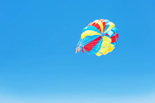 istock Multi coloured parachute on the blue sky background with copy space. Concept holiday fun activities. 1367651574