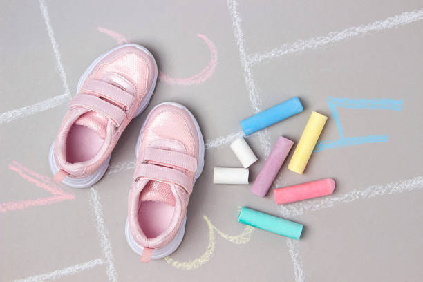Pink sneakers and hopscotch game. Top view Flat lay stock photo
