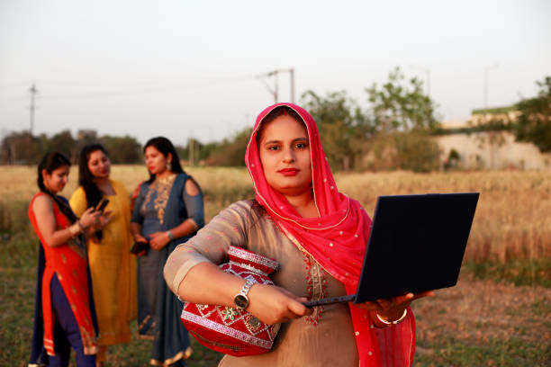 istock Indian women using laptop outdoor in nature 1367653539