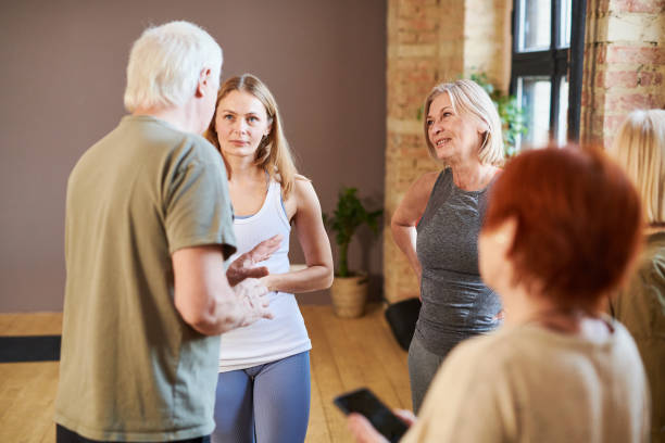 istock Senior people talking to their fitness instructor 1367657176