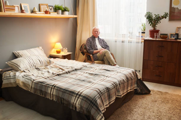 Senior man sitting in his bedroom
