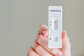 Hands holding Covid-19 rapid antigen test cassette with negative result of rapid diagnostic test