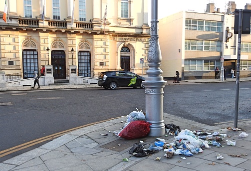 10th December 2021, Dublin, Ireland.  Opened rubbish bags against a lamp pole opposite the Davenport Hotel on Merrion Street Lower, in Dublin city centre.