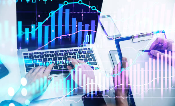 istock Business people hands with laptop and clipboard, graph lines with candlesticks 1367664161