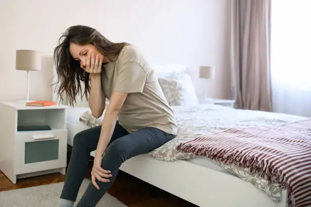 Pregnant woman having morning sickness. About 25 years old, Caucasian brunette.