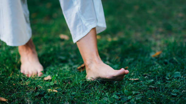 Yoga Woman Walking barefoot, focus on feet. stock photo