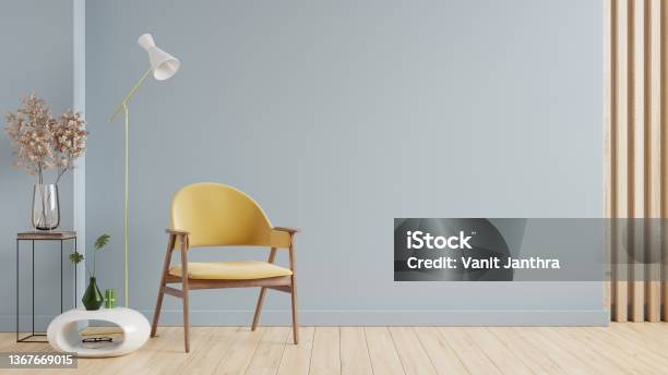Mockup Living Room Interior With Yellow Armchair On Empty Blue Color Wall Background Stock Photo - Download Image Now