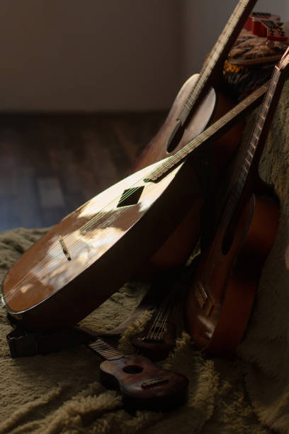 istock Stringed musical instruments, real and toy, lie on the couch 1367670427