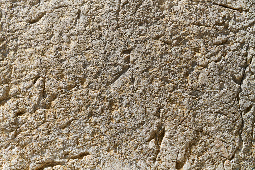 Scratched travertine rock background.