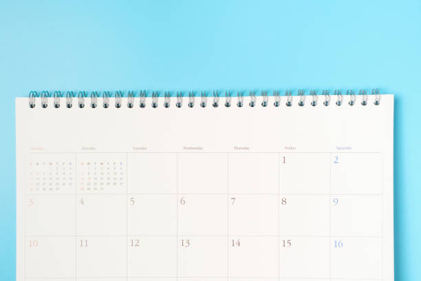 istock White calendar on blue background close up with copy space. 1367672029