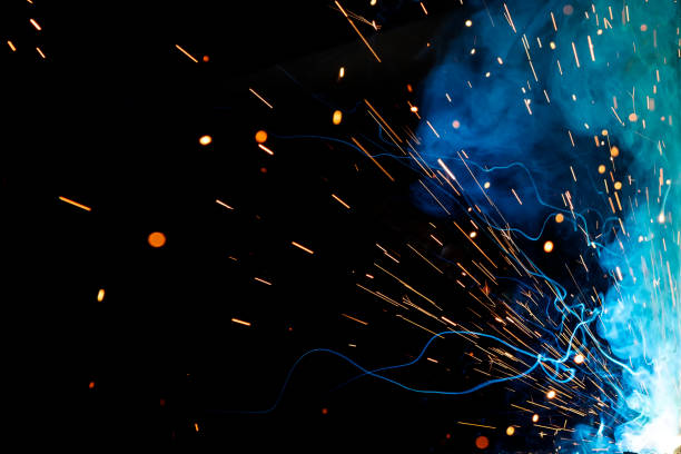 close up view and background of the gas metal arc welding (gmaw) process with sparks, light, bokeh effect and smoke. - sparks imagens e fotografias de stock