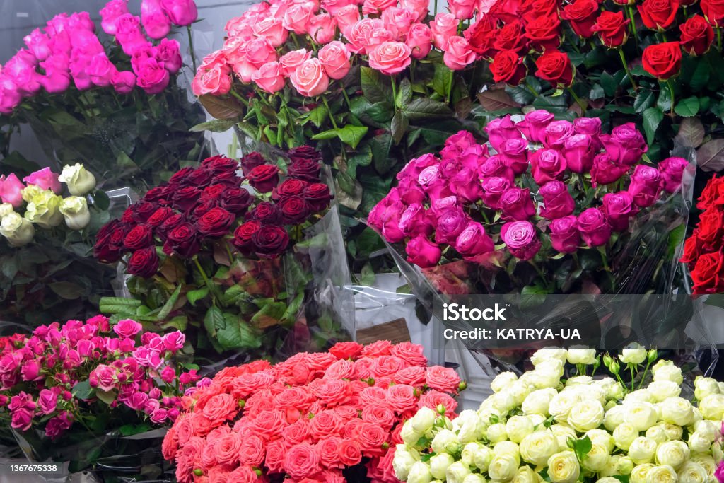 Bouquet of colorful roses and other different flowers at the entrance of the flower store. Showcase. Beautiful flowers for a catalog, online store. Flower business. Concept flower store and delivery. Rose - Flower Stock Photo