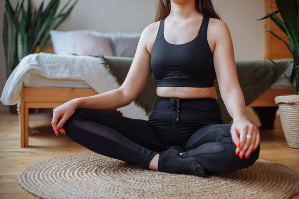 istock Young woman doing yoga at home 1367675413