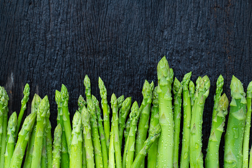 Raw asparagus. Fresh Asparagus on wooden background