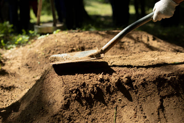 istock Undertaker strikes grave. Shovel and earth. Man is digging ground. Sand ramming. 1367677643