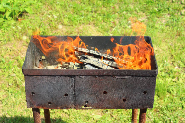 istock Firewood burning in the grill. Close-up. Background. 1367678183