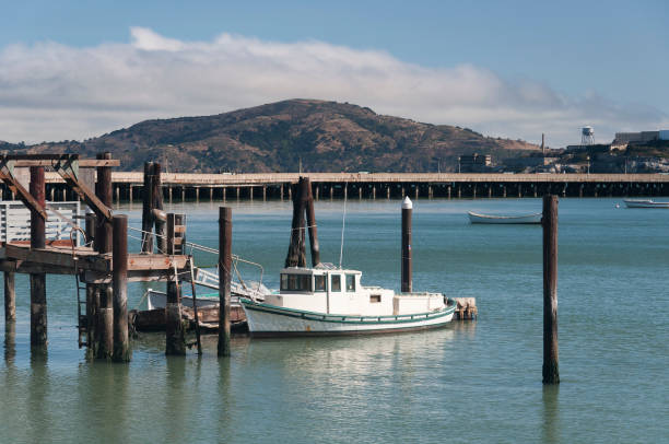 A fishing trawler docked at a wooden pier stock photo