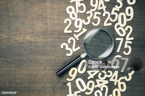 Magnifying Glass In Scattered Numbers Stock Photo - Download Image Now - Number, Confusion, Mathematics