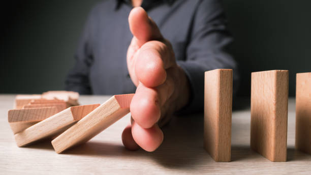 istock Man stop the crisis from domino effect 1367679445