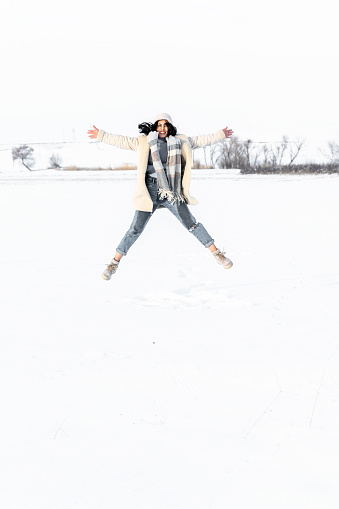 Young Woman having fun in the Snow at Winter