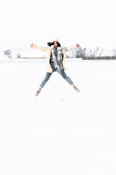 Young Woman having fun in the Snow at Winter stock photo