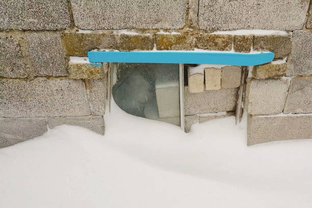 bricks and cinder blocks from the bus window on the front wall with snow in winter.