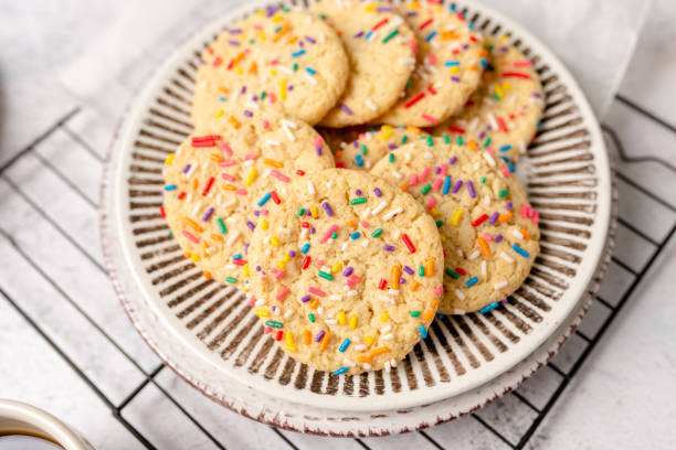 Sugar cookies with rainbow sprinkles Sugar cookies with sprinkles, colorful coffee treat. freshly baked dessert cookies. round sugar cookie stock pictures, royalty-free photos & images