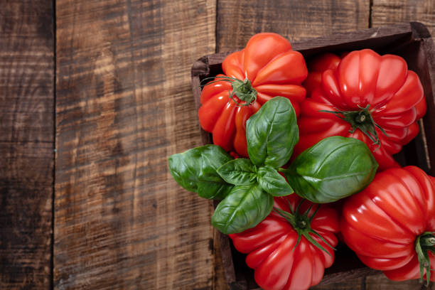 Tomatoes coeur with basil leaf,  close up.
