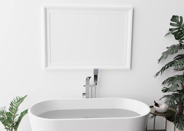 istock Empty horizontal picture frame on white wall in modern and luxury bathroom. Mock up interior in contemporary style. Free space, copy space for your picture, poster. Bath, table, plants. 3D rendering. 1367684588