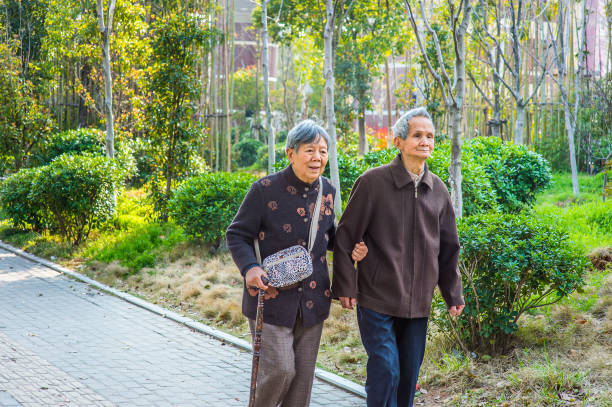 istock Senior Man and Woman Walking Outside. 1367684936